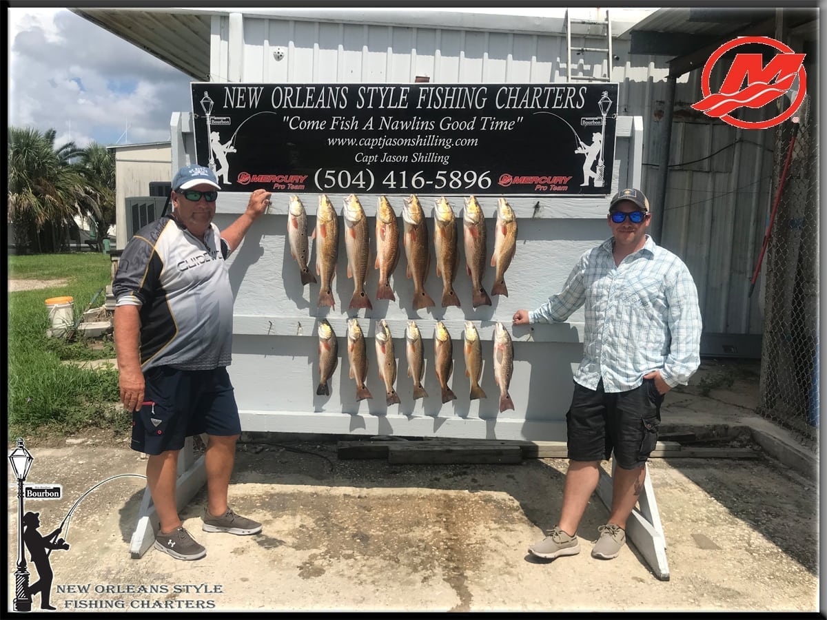 Couple of guys catch redfish together with New Orleans Style Fishing Charter